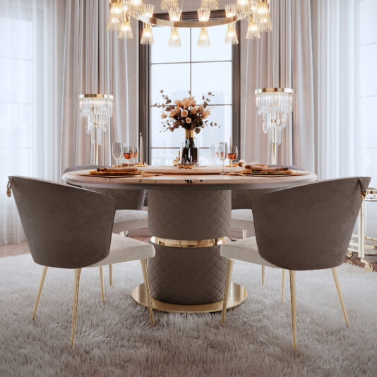 Transform your dining area into an elegant haven with the Round Marble Dining Set With Lazy Susan, characterized by its plush, quilted base and paired with two upholstered chairs. The table is gorgeously arranged with gold-accented dinnerware and a vibrant floral centerpiece. The luxurious atmosphere is further enhanced by crystal chandeliers and large windows adorned with sheer curtains.