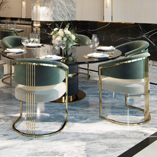 A luxurious dining setup features a round glass table with a black base, surrounded by four elegant Two-Tone Art Deco Style Curved Dining Chairs with gold metal frames and green velvet upholstery. The table is adorned with a floral arrangement, plates, glasses, and cutlery, set on a polished marble floor.