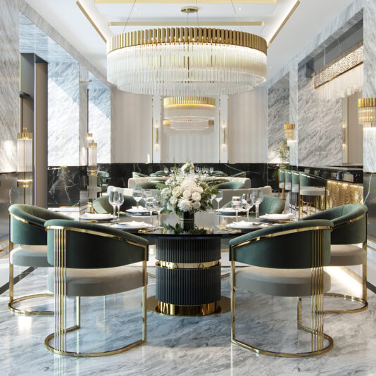 Two-Tone Art Deco Style Curved Dining Chair A lavish dining room showcases a spacious round table adorned with an elegant flower centerpiece. Encircling the table are Two-Tone Art Deco Style Curved Dining Chairs, featuring plush green velvet upholstery and exquisite gold accents. The room is further enhanced by marble floors and walls, contemporary chandeliers, and opulent gold decorative elements.