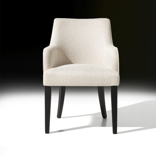 The High End Leather Backed Dining Chair, featuring a beige upholstered seat and sleek, dark wooden legs, is positioned against a gradient background transitioning from light to dark. This chair boasts clean lines and a slightly reclined backrest, seamlessly blending contemporary and minimalist design elements.
