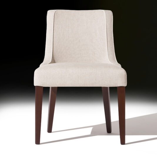 The High End Occasional Chair, featuring a beige upholstered finish, boasts a sleek and modern design with a gently curved backrest supported by four dark wooden legs. It is set against a gradient background that transitions smoothly from white to black.
