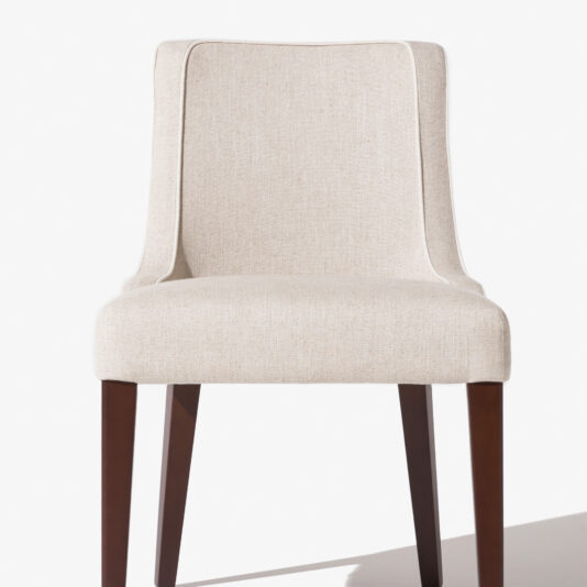 The High End Occasional Chair features a beige upholstered seat, a slightly curved backrest, and dark wooden legs. Set against a white background, this premium dining chair exudes a clean, minimalist design.