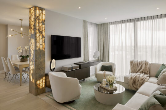 Luxury apartment in Battersea London designed in quite luxury style, with soft mint green tones, enhanced with white and gold. Living flowing into the dining room with a bespoke light up wall