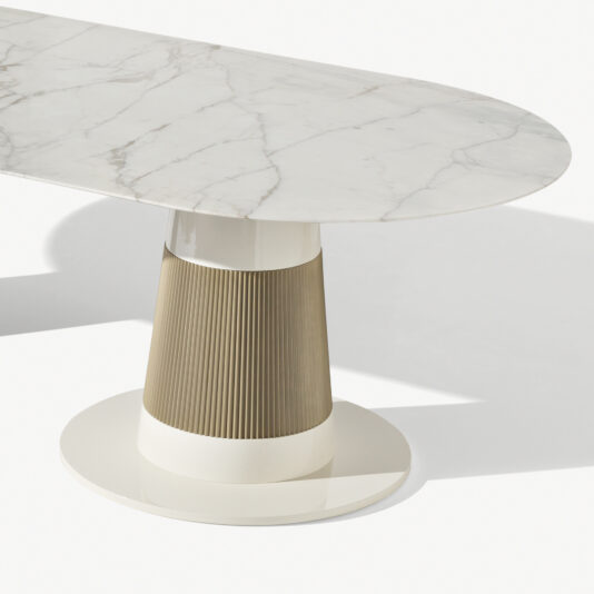 High End Contemporary Marble Oval Dining Table Experience the elegance of the High End Contemporary Marble Oval Dining Table, boasting a cylindrical base with a sophisticated ribbed texture and a sleek glossy finish. The polished marble tabletop features striking white and grey veining, adding to its refined aesthetic. This minimalist design offers a blend of modernity and elegance, perfectly set against a plain white background.