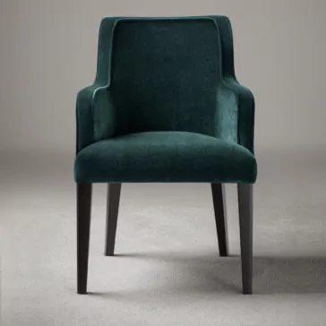 High End Occasional Velvet Armchair An emerald green High End Occasional Velvet Armchair with a modern design. Featuring clean lines, curved armrests, and sturdy black wooden legs, this chair is placed against a neutral background to highlight its sleek and elegant appearance.