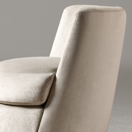 Curved Occasional Chair With Swivel Base A close-up image of the Curved Occasional Chair With Swivel Base, featuring modern beige upholstery and set against a neutral gray background. The chair showcases a smooth, curved backrest and a visible plush cushion on the seat, emphasizing its comfortable and contemporary design.