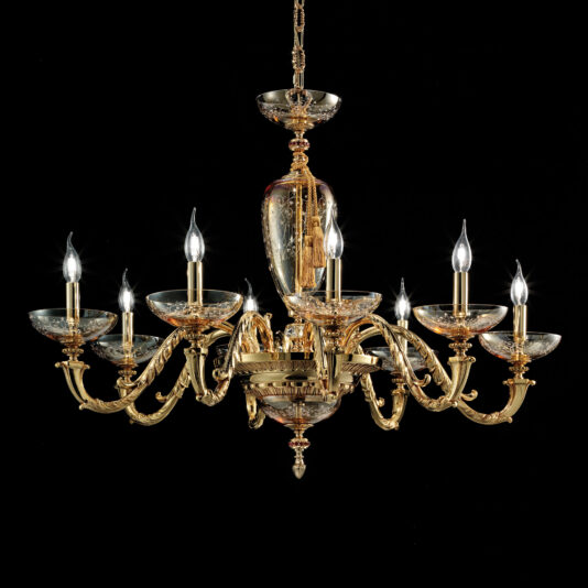 Amber Hand Blown Glass Chandelier The Amber Hand Blown Glass Chandelier, adorned with nine candle-shaped light bulbs and luxurious gold trim, is elegantly suspended against a black background. Its intricate design showcases ornate, curved arms and amber hand-blown glass details, reflecting its classical and elegant style.