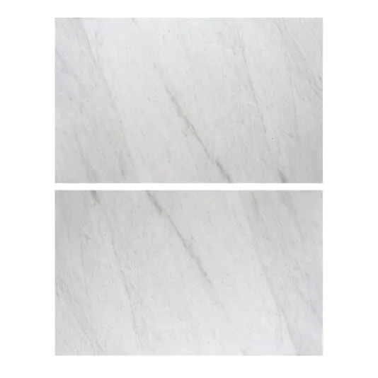 Exclusive Round Marble Dining Table Two rectangular white marble tiles with delicate grey veining are arranged horizontally, one above the other. They exhibit a smooth, polished surface and a natural stone pattern that perfectly complements the Exclusive Round Marble Dining Table.