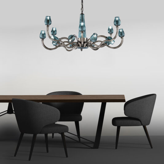 Large Contemporary Teal Glass Chandelier Modern dining space featuring a sleek wooden table with black metal legs, surrounded by four black, curved-back chairs. Above the table hangs the Large Contemporary Teal Glass Chandelier with sinuous arms, set against a plain, light-colored wall.