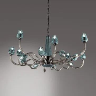 Large Contemporary Teal Glass Chandelier The Large Contemporary Teal Glass Chandelier boasts a metallic frame with multiple curved, wavy arms that each hold a teal, cone-shaped light cover. This elegant chandelier is suspended by a chain against a plain gray background.