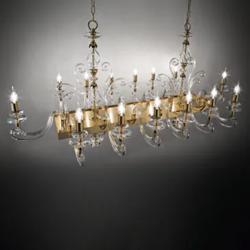 The Rectangular Classic Candle Style Chandelier boasts a sophisticated design with multiple swirling glass arms, each showcasing a traditional candle-style bulb. This fixture is adorned with intricate glass detailing and features an elegant gold frame, suspended by dual chains. It casts a refined ambiance against a neutral background.