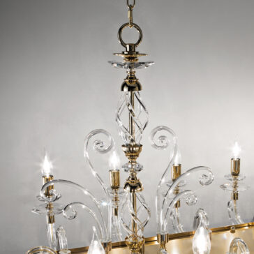 A close-up shot of the Rectangular Classic Candle Style Chandelier showcasing its intricate glass and gold designs. The chandelier features twisted glass arms and candle-like light bulbs, an elegant spiral central column, and is suspended from a chain against a neutral gray background.