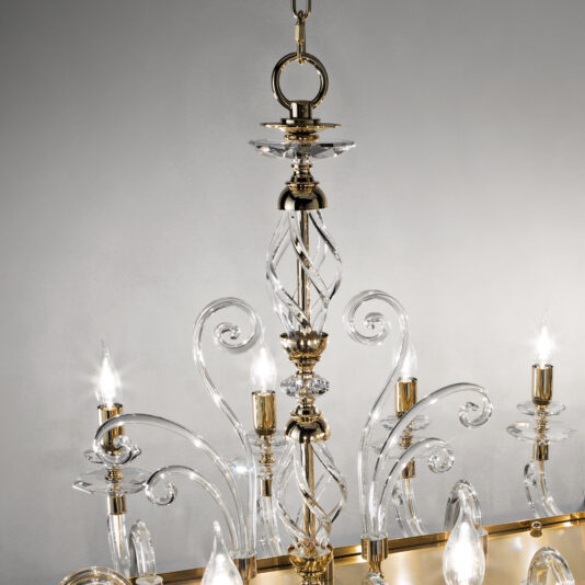 A close-up shot of the Rectangular Classic Candle Style Chandelier showcasing its intricate glass and gold designs. The chandelier features twisted glass arms and candle-like light bulbs, an elegant spiral central column, and is suspended from a chain against a neutral gray background.
