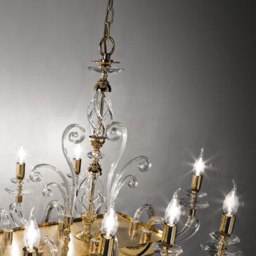 The Rectangular Classic Candle Style Chandelier, with its luxurious golden metal and crystal accents, hangs gracefully from a chain. Featuring multiple lit candle-shaped bulbs, clear crystal arms, and intricate detailing, this rectangular masterpiece shines elegantly against a neutral-toned background.