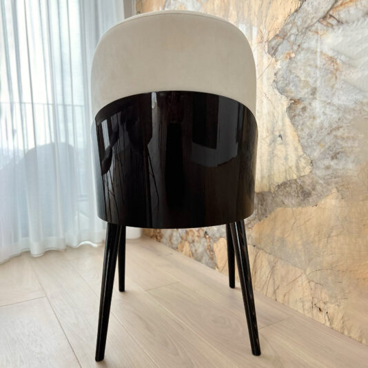 Art Deco Style Dining Chair back of a modern Art Deco dining chair in ivory and dark wood close up