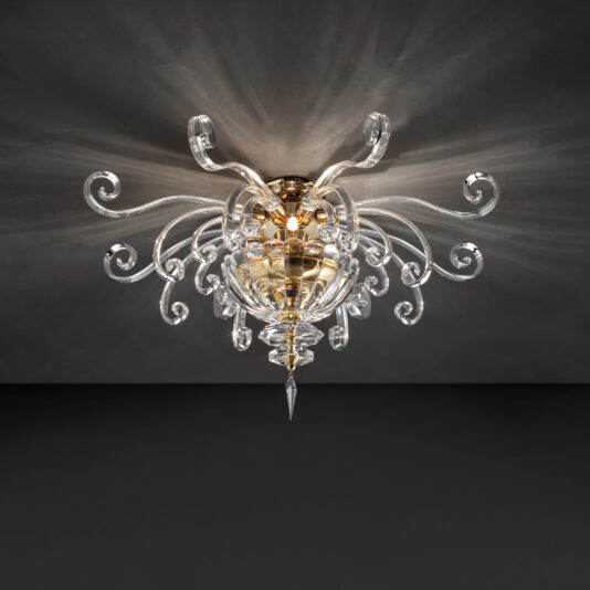 The Contemporary Glass Swirl Ceiling Light exudes luxury with its intricate, ornate design. This chandelier features a central golden sphere surrounded by multiple swirling, transparent glass arms that extend outward, each ending in crystal-like decorative elements. It casts elegant patterns across the dark ceiling.