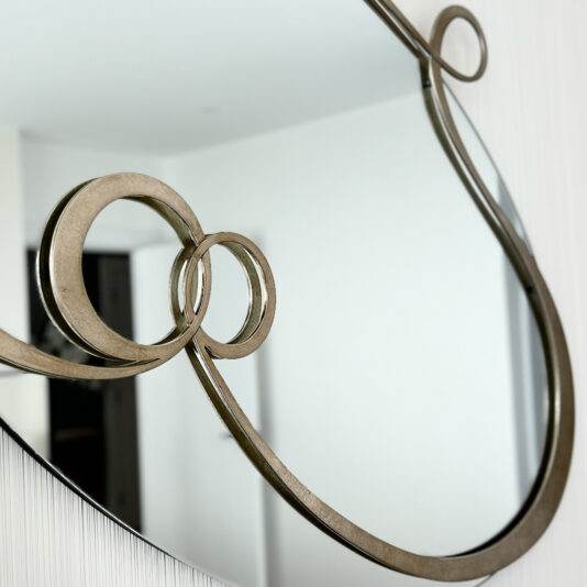 Contemporary Twisted Oval Mirror close up of a designer gold ornate modern mirror