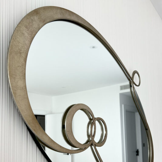 Contemporary Twisted Oval Mirror designer gold metal pattern on a mirror close up