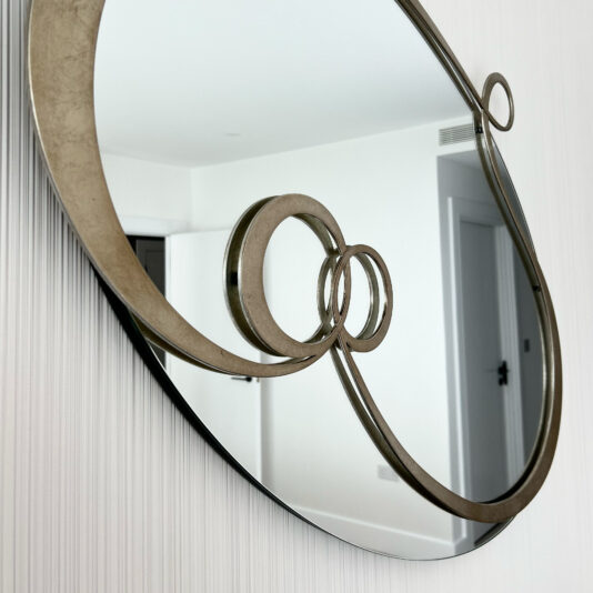 Contemporary Twisted Oval Mirror designer gold mirror with metal swirl on a mirror