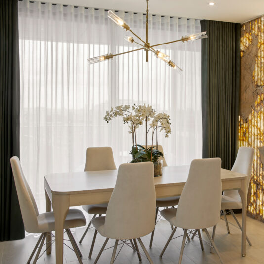 High-Back Curved Dining Chair Luxury dining room with dining table and chairs, modern chandelier and feature wall