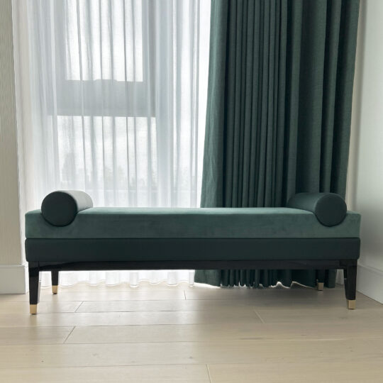 Green contemporary designer bench with bolster