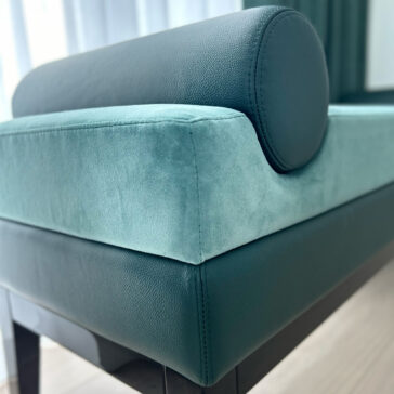 Mid-Century Style Bench Green velvet and green leather contemporary designer bench with bolster cushion inside the bench close-up