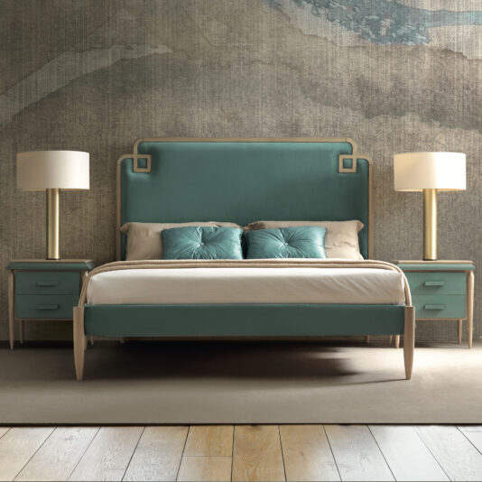 Luxury Art Deco Style Bed A modern bedroom features the Luxury Art Deco Style Bed in a luxurious teal upholstery with a large headboard and decorative pillows. Two matching nightstands with drawers flank either side of the bed, each adorned with a tall, gold-based lamp. The room is accented with textured wallpaper and light wood flooring.