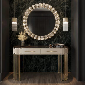 Luxurious vanity setup with a round, illuminated mirror above a sleek, gold-accented console table. Two pendant lights hang on either side. The background features a dark, textured wall, enhancing the elegant and modern aesthetic.