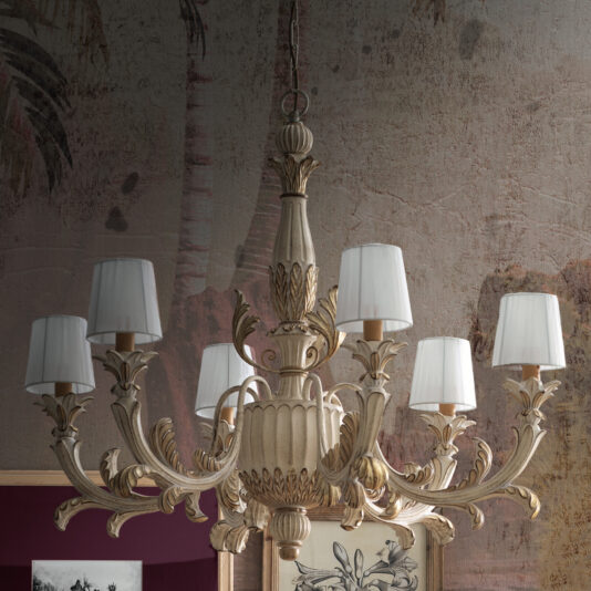The Classic Style Ornate Chandelier, featuring eight intricately detailed arms each supporting a small white lampshade, hangs gracefully from the ceiling. The warm-toned wallpaper, adorned with subtle palm leaf patterns, enhances the setting with its vintage and elegant ambiance.