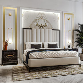 A modern bedroom featuring a luxurious bed with a tall, upholstered headboard, flanked by two dark wood nightstands. The wall has marble detailing, gold accents, and pendant lights. A patterned rug covers the wooden floor, and a plant sits in the corner.