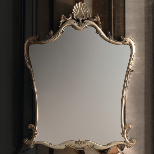 Introducing the Large Rococo Style Wall Mirror, boasting an ornate rectangular design with a decorative frame adorned with intricate carvings and crowned by a striking shell motif, all set against a plain background.