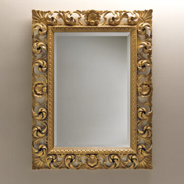 An Ornate Baroque Style Wall Mirror with intricate floral patterns adorns a plain, light-colored wall. The gold frame exudes elegance and an antique charm but features a blank canvas rather than the anticipated mirror or picture.