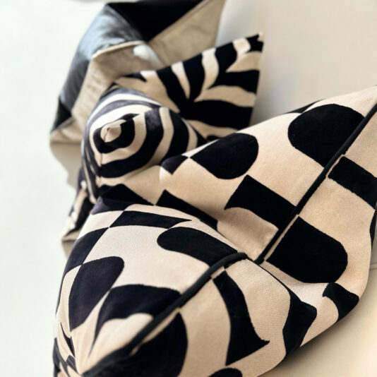 Close-up of the Luxury Velvet Retro Pattern Scatter Cushion, showcasing black and white geometric designs in pointy, triangular forms set against a neutral background, creating a striking abstract look.