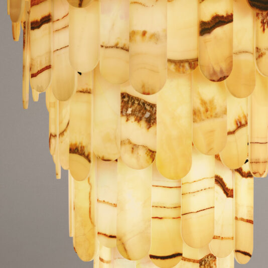 Modern Onyx Tiered Ceiling Light A close-up of the Modern Onyx Chandelier (Copy) reveals vertical, overlapping pieces in warm yellow and orange tones, with light highlighting the natural patterns and veining in the stone.