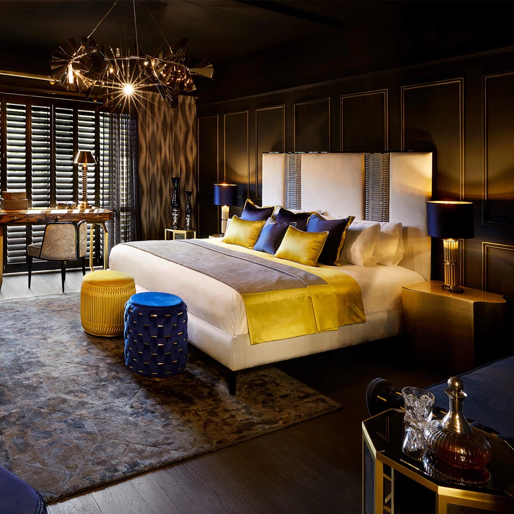 A colour drenched bedroom with dark browns and luxury satin bedspread