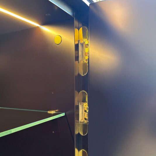 Close-up of the glass shelf inside the Luxury Art Deco Style Sunburst Sideboard, featuring an illuminated yellow strip above, a concealed hinge on the open door, and sleek matte black interior panels.