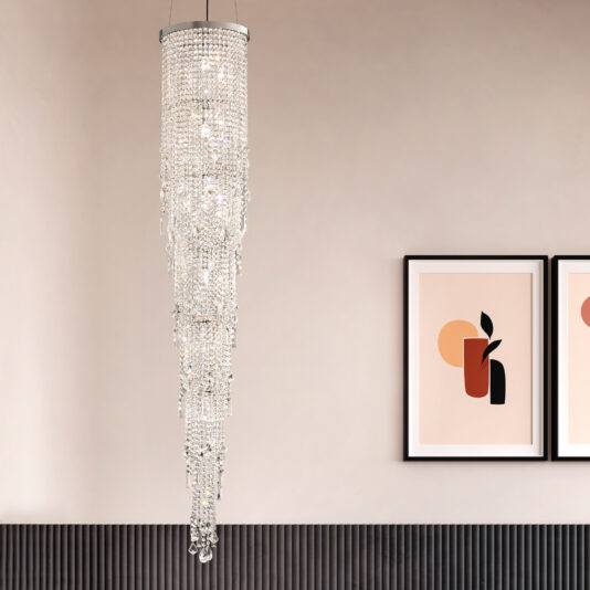 Cut crystal strands cascade from the ceiling with a Chandelier Style Cut Crystal Wall Light, illuminating a modern, elegant space. Framed abstract artworks with geometric shapes and muted colors adorn the wall, enhancing the sophisticated atmosphere.