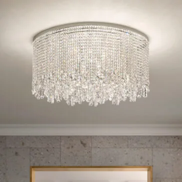 A Rectangular Smoked Cut Crystal Ceiling Light enhances the white ceiling, casting reflections from its many crystals. The light gray, subtly textured walls complement a partially visible wooden frame at the bottom.