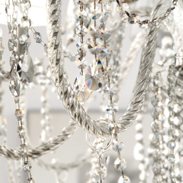 Close-up of the Classic Style Clear Crystal Chandelier, featuring intricate twisted metalwork and glass crystals that reflect light, creating sparkling rainbow-like effects.