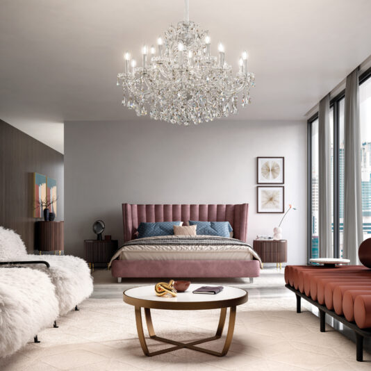 A modern bedroom with a Classic Style Tiered Crystal Chandelier, pink upholstered bed, nightstands, white and gold coffee table, rust bench, white fur chairs, and floor-to-ceiling windows overlooking the city.