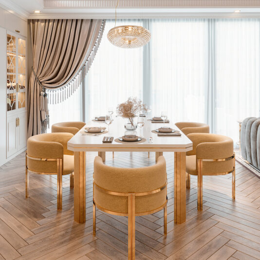 The dining room showcases a wooden herringbone floor and the Contemporary Dining Table and Chairs Set in white. Six curved beige chairs surround the square table with plates and glasses, beneath a crystal chandelier. Tall windows with sheer curtains bathe the room in natural light.