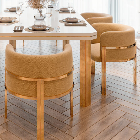 A modern dining room displays the Contemporary Dining Table And Chairs Set with place settings. The white table pairs with beige upholstered chairs highlighted by gold accents, while light brown herringbone wood flooring elegantly reflects natural light through sheer curtains.