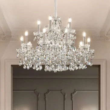 Large Classic Style Crystal Chandelier The Large Classic Style Crystal Chandelier with candle-shaped bulbs and ornate crystal drops hangs from a white ceiling, complemented by elegant decorative trim and classic wall paneling in the background.