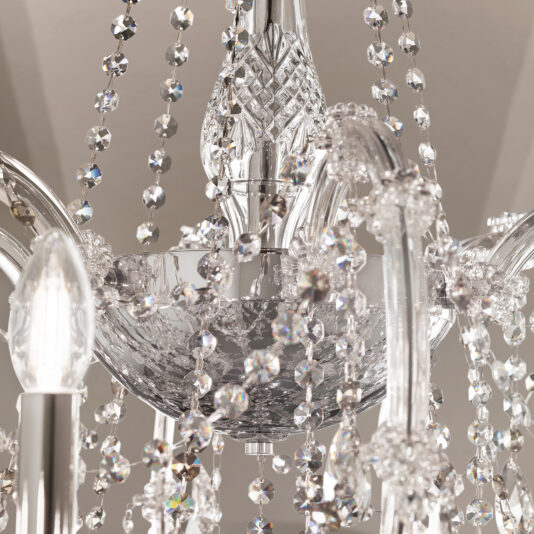 Close-up of the Large Classic Style Crystal Chandelier featuring faceted glass beads and curved metal arms, reflecting light for sparkling patterns.