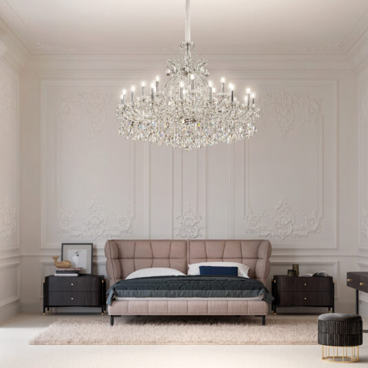 A luxurious bedroom features ornate white walls, a tufted beige bed with dark bedding, two black nightstands, and a Classic Style Tiered Crystal Chandelier (Copy) overhead. Framed art and books rest on the nightstands.
