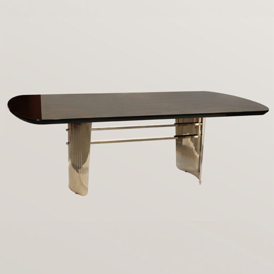 The Large Modern Veneered Dining Set features a sleek, dark wooden top with curved metal legs supported by a horizontal bar. The shiny veneered legs add a contemporary touch against the plain, light-colored background.