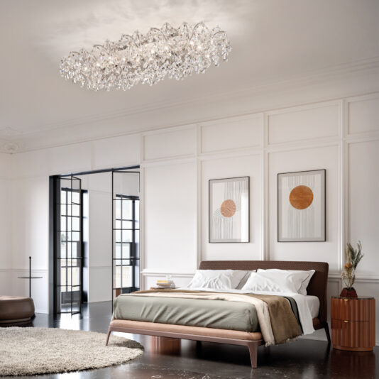 Oval Crystal Ceiling Light A contemporary bedroom with a low wooden bed, neutral bedding, abstract art, round rug, and black-framed floor-to-ceiling windows is beautifully lit by the Round Crystal Ceiling Light (Copy).