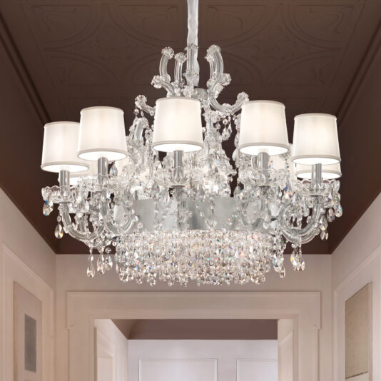 The Round Silver Leaf Crystal Chandelier, featuring multiple arms, white lampshades, and crystal ornaments, hangs elegantly from the ceiling in the hallway.