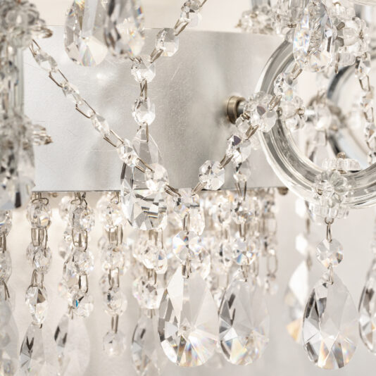 Close-up of the Classic Style Clear Crystal Chandelier (Copy), showcasing teardrop-shaped crystals and faceted beads on silver chains that reflect light, creating a sparkling and elegant effect.