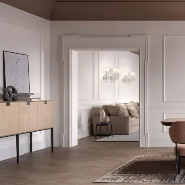 Silver Leaf Crystal Wall Light A modern living room with light wood furniture, a beige sofa, wall paneling, and elegant Classic Style Clear Crystal Wall Light (Copy) sconces. Neutral tones, contemporary decor, and a view into the adjacent seating area complete the space.